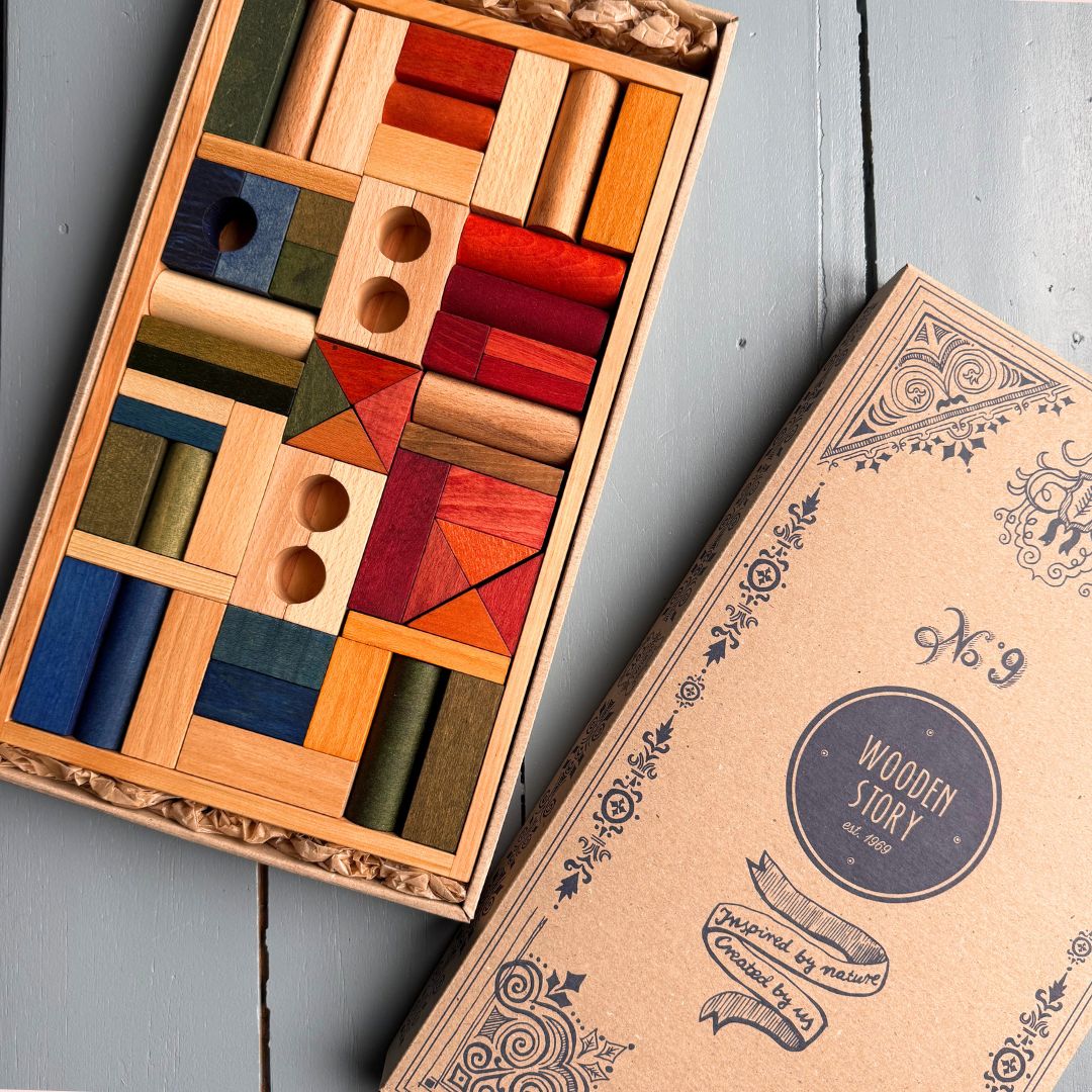 Bovenaanzicht van de Wooden Story set met 54 naturel houten bouwblokken in een houten bak